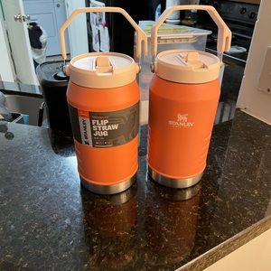 1 new, 1 lightly used 64oz grapefruit Stanley water jug